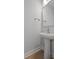 Modern powder room with pedestal sink, sleek faucet, and contemporary mirror at 778 Maynard Ln, Summerville, SC 29486