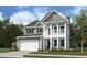 Charming two-story home with a welcoming porch, lush lawn, and attached garage at 785 Maynard Ln, Summerville, SC 29486