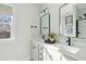Bright, modern bathroom with double sinks, black fixtures, and ample natural light at 786 Maynard Ln, Summerville, SC 29486