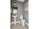Modern powder room featuring a pedestal sink, framed artwork, and contemporary fixtures at 786 Maynard Ln, Summerville, SC 29486