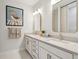 Bathroom with double sinks, large mirrors, modern light fixtures, and bright, natural light at 786 Maynard Ln, Summerville, SC 29486