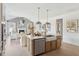 Open-concept kitchen with stainless steel appliances, a center island and hardwood floors overlooking living area at 786 Maynard Ln, Summerville, SC 29486