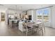 Open kitchen with stainless appliances, white cabinets, a breakfast bar, and a dining table at 786 Maynard Ln, Summerville, SC 29486