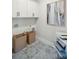 Well-organized laundry room with overhead cabinets and elegant patterned tile flooring at 786 Maynard Ln, Summerville, SC 29486