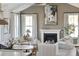 Bright living room featuring a fireplace, large windows with white curtains, and stylish neutral furniture at 786 Maynard Ln, Summerville, SC 29486
