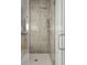 Modern shower with gray vertical tiling, brushed metal fixtures, and frameless glass door at 786 Maynard Ln, Summerville, SC 29486