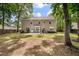 A backyard with a lush lawn, patio seating, and a view of the two-story home at 8328 Berringer Bluff, North Charleston, SC 29418