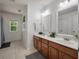 Bathroom with double vanity, wood cabinets, and neutral tile flooring at 8328 Berringer Bluff, North Charleston, SC 29418
