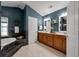 Bright bathroom features a soaking tub, double vanity with wood cabinets, and neutral tile flooring at 8328 Berringer Bluff, North Charleston, SC 29418