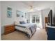 Bright bedroom with ceiling fan and natural light, features a large bed with blue accents at 8328 Berringer Bluff, North Charleston, SC 29418