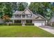 Charming two-story home featuring a covered porch, well-maintained lawn, and attached garage at 8328 Berringer Bluff, North Charleston, SC 29418