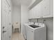 Functional laundry room with washer, dryer, storage cabinets, and sink at 8328 Berringer Bluff, North Charleston, SC 29418