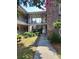 Charming brick apartment building exterior with landscaped courtyard and walkway at 867 Colony Dr # F 118, Charleston, SC 29407