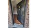 Inviting front door with gold accents, brick surround, and hardwood floors inside at 867 Colony Dr # F 118, Charleston, SC 29407
