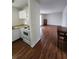 Open kitchen view with white cabinetry, adjoining living space, and hardwood floors at 867 Colony Dr # F 118, Charleston, SC 29407