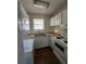 Efficient kitchen with white appliances, compact design, and functional layout at 867 Colony Dr # F 118, Charleston, SC 29407