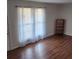 Bright living room with hardwood floors, sheer curtains and a minimalist aesthetic at 867 Colony Dr # F 118, Charleston, SC 29407