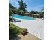 Sparkling community pool with lounge chairs, a sun deck, and lush surroundings at 867 Colony Dr # F 118, Charleston, SC 29407