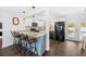 Open kitchen with bar seating, granite counters, white cabinets, stainless appliances, and dark wood floors at 8767 Auburn Dr, North Charleston, SC 29406