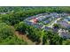 Aerial view of townhome community near a forest with neighborhood streets and lawns at 9079 Parlor Dr, Ladson, SC 29456