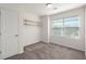 Bedroom featuring a window, neutral carpeting, shelving, and crisp white paint at 9079 Parlor Dr, Ladson, SC 29456