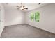 Bright bedroom features neutral carpet, ceiling fan, and sun-filled window at 9079 Parlor Dr, Ladson, SC 29456