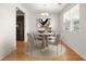 Elegant dining area with hardwood floors, a stylish chandelier, and a large window at 9079 Parlor Dr, Ladson, SC 29456