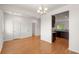 Bright dining room with hardwood floors, chandelier, and seamless access to the adjacent kitchen area at 9079 Parlor Dr, Ladson, SC 29456