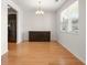 Bright dining room with hardwood floors, chandelier, and seamless access to the adjacent kitchen area at 9079 Parlor Dr, Ladson, SC 29456