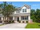 Charming two-story home with a welcoming front porch, well-manicured lawn, and a concrete driveway at 9079 Parlor Dr, Ladson, SC 29456