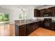 Modern kitchen featuring granite countertops, stainless steel appliances, and dark wood cabinets at 9079 Parlor Dr, Ladson, SC 29456