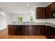 Modern kitchen featuring granite countertops, stainless steel appliances, and dark wood cabinets at 9079 Parlor Dr, Ladson, SC 29456