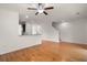 Hardwood floors, ceiling fan, and open access to kitchen and stairs at 9079 Parlor Dr, Ladson, SC 29456