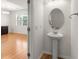 Convenient half bath with pedestal sink and decorative mirror at 9079 Parlor Dr, Ladson, SC 29456