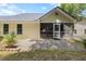 Exterior view of the home with a screened-in porch, brick patio, and neutral siding at 9091 Delancey Cir, North Charleston, SC 29406