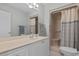 Bathroom featuring vanity, mirror, shower stall with beige curtain and toilet at 9091 Delancey Cir, North Charleston, SC 29406