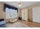 Flex room with large window, hardwood floors, armoire, and pet bed at 9091 Delancey Cir, North Charleston, SC 29406
