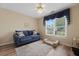 Flex room with love seat, pet bed, hardwood floors and large window at 9091 Delancey Cir, North Charleston, SC 29406