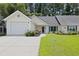 Charming single-story home with a well-maintained lawn, landscaping, and a two-car garage at 9091 Delancey Cir, North Charleston, SC 29406