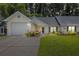 Charming single-story home with attached garage, well-manicured lawn, and welcoming front porch at 9091 Delancey Cir, North Charleston, SC 29406
