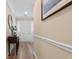 Entry hallway with wood floors and neutral walls with white trim at 9091 Delancey Cir, North Charleston, SC 29406