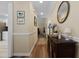 Bright hallway with wood floors, leading to other areas of the home at 9091 Delancey Cir, North Charleston, SC 29406