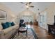 Cozy living room featuring vaulted ceilings, bright windows, and comfortable seating at 9091 Delancey Cir, North Charleston, SC 29406