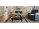 Comfortable living room showcases a sofa, chair, lamps, an area rug, and wood flooring at 9091 Delancey Cir, North Charleston, SC 29406