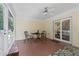 Relaxing sunroom featuring a ceiling fan, neutral decor, and access to the outdoors at 9091 Delancey Cir, North Charleston, SC 29406
