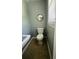 Bathroom with tile floor, toilet, sink, mirror, and window at 980 Margaret Dr, Ladson, SC 29456