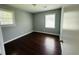Bedroom with hardwood floors, two windows, and light gray walls provides ample natural light at 980 Margaret Dr, Ladson, SC 29456