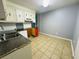 Galley kitchen features white cabinets, dishwasher, and stainless steel sink at 980 Margaret Dr, Ladson, SC 29456