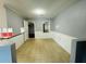 The living room has neutral walls, tile flooring and looks into the kitchen at 980 Margaret Dr, Ladson, SC 29456