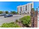 Apartment building features on-site parking, mature landscaping, and nearby coastal location at 1 King # 702, Charleston, SC 29401